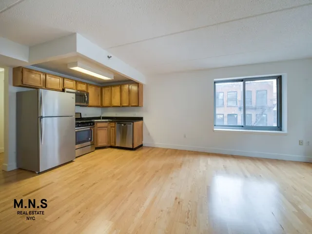 a view of kitchen with furniture and stainless steel appliances
