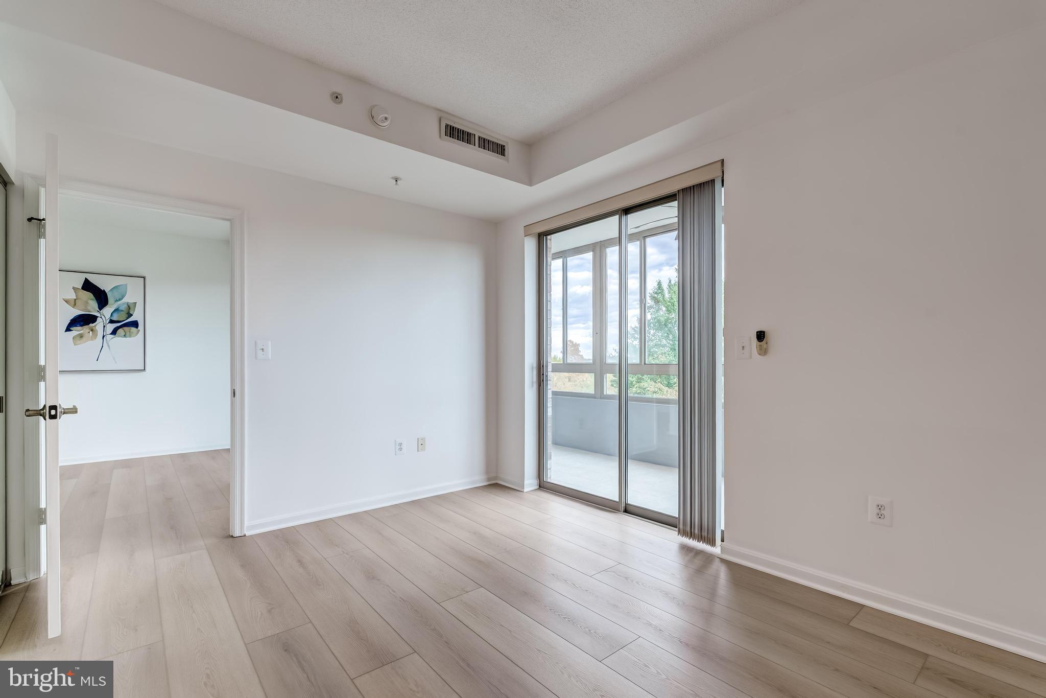 19355 Cypress Ridge Terrace, Unit 114 Leesburg, VA 20176 - Photo 11 of 42 wooden floor in an empty room