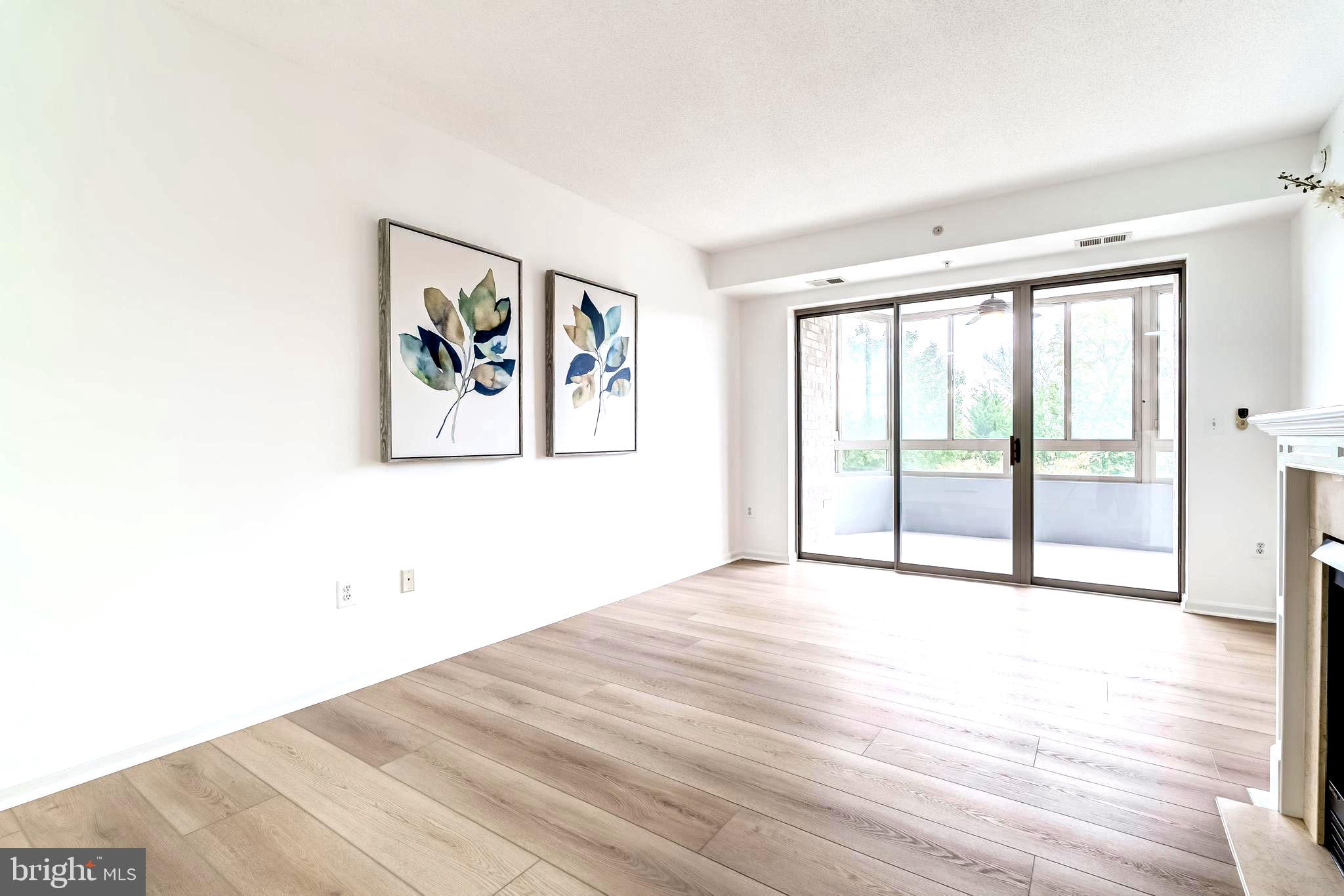19355 Cypress Ridge Terrace, Unit 114 Leesburg, VA 20176 - Photo 18 of 42 a view of an empty room with wooden floor and a window