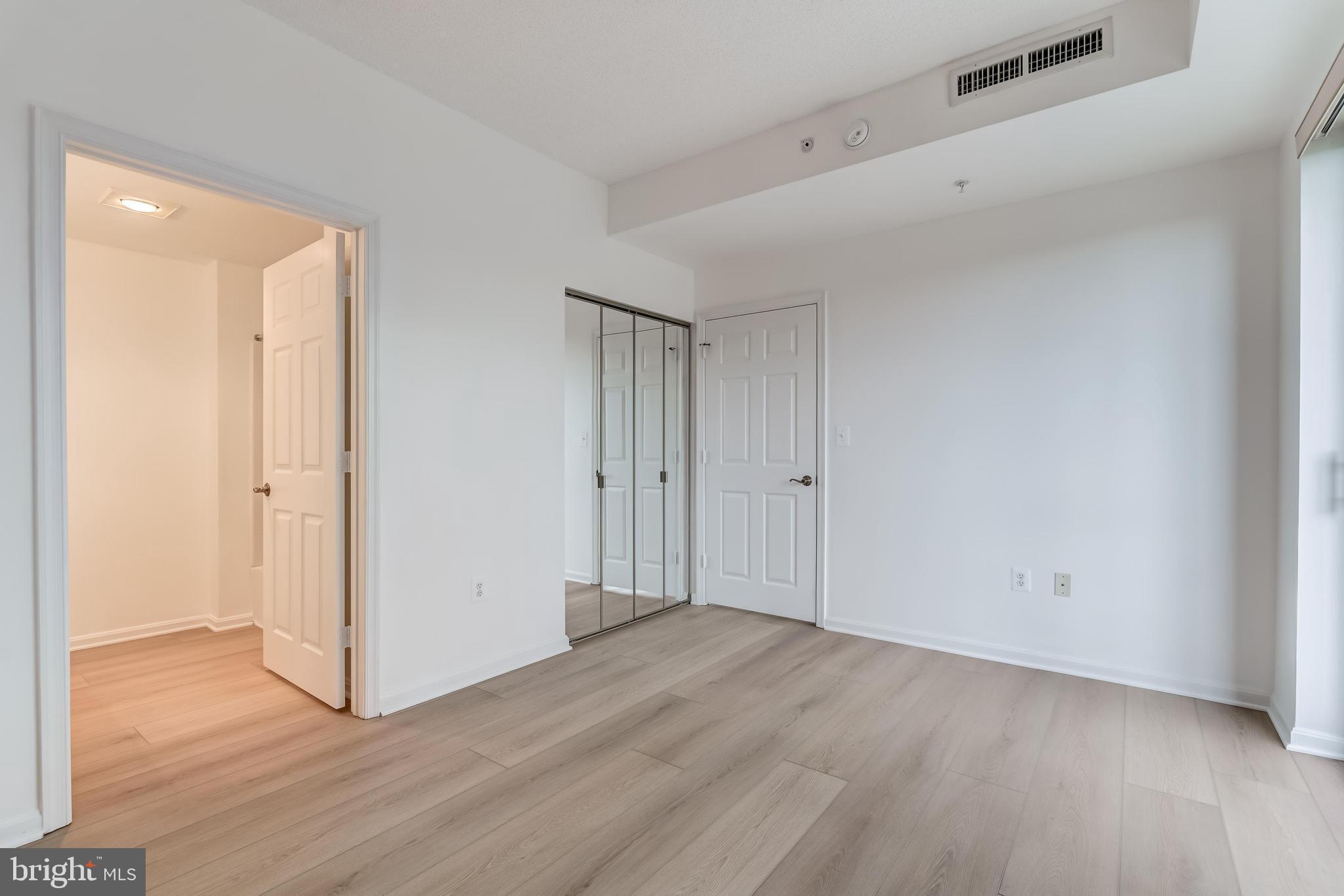 19355 Cypress Ridge Terrace, Unit 114 Leesburg, VA 20176 - Photo 23 of 42 a view of an empty room with wooden floor