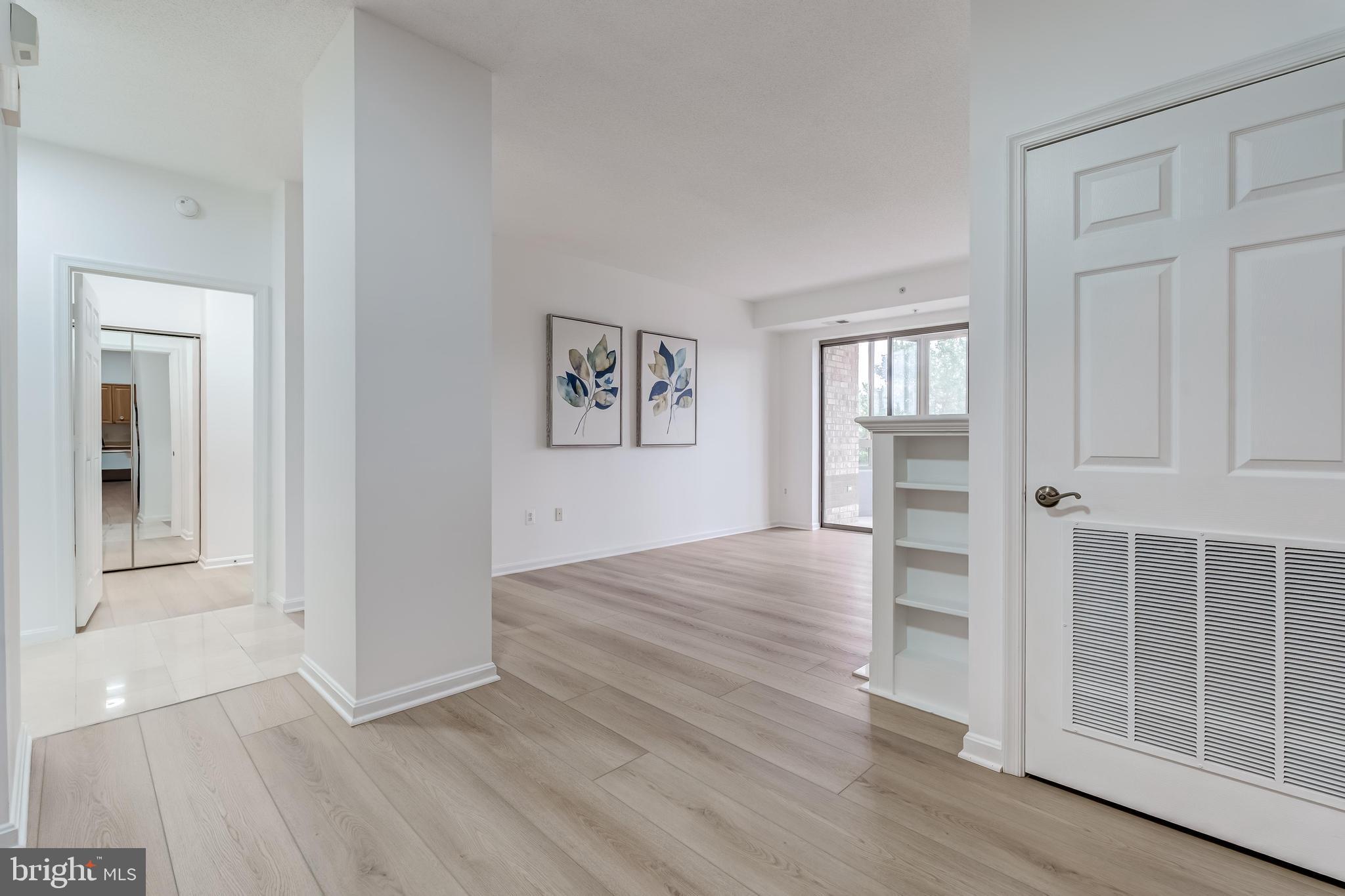 19355 Cypress Ridge Terrace, Unit 114 Leesburg, VA 20176 - Photo 4 of 42 a view of wooden floor and windows in a room
