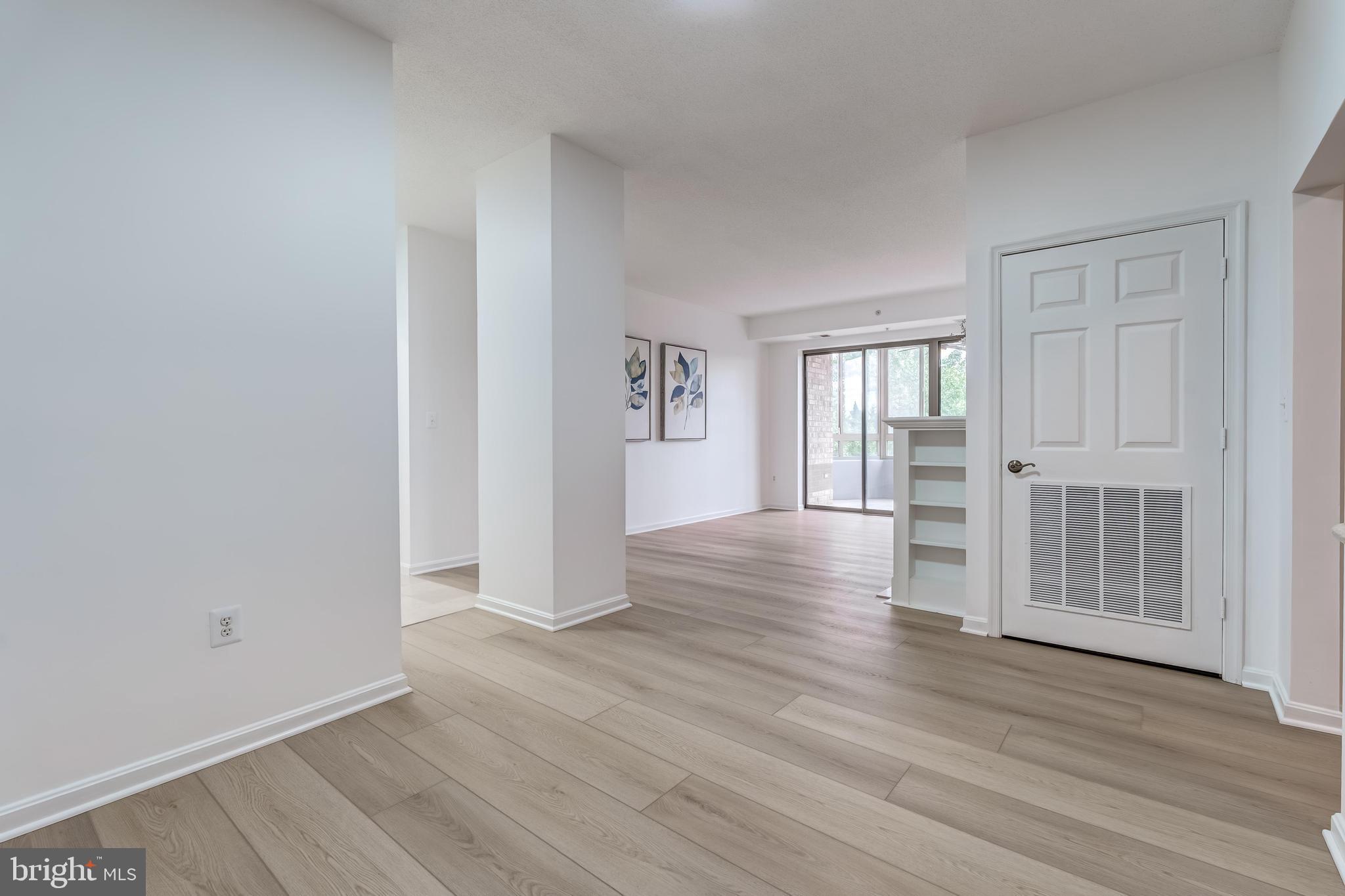 19355 Cypress Ridge Terrace, Unit 114 Leesburg, VA 20176 - Photo 5 of 42 wooden floor with white walls