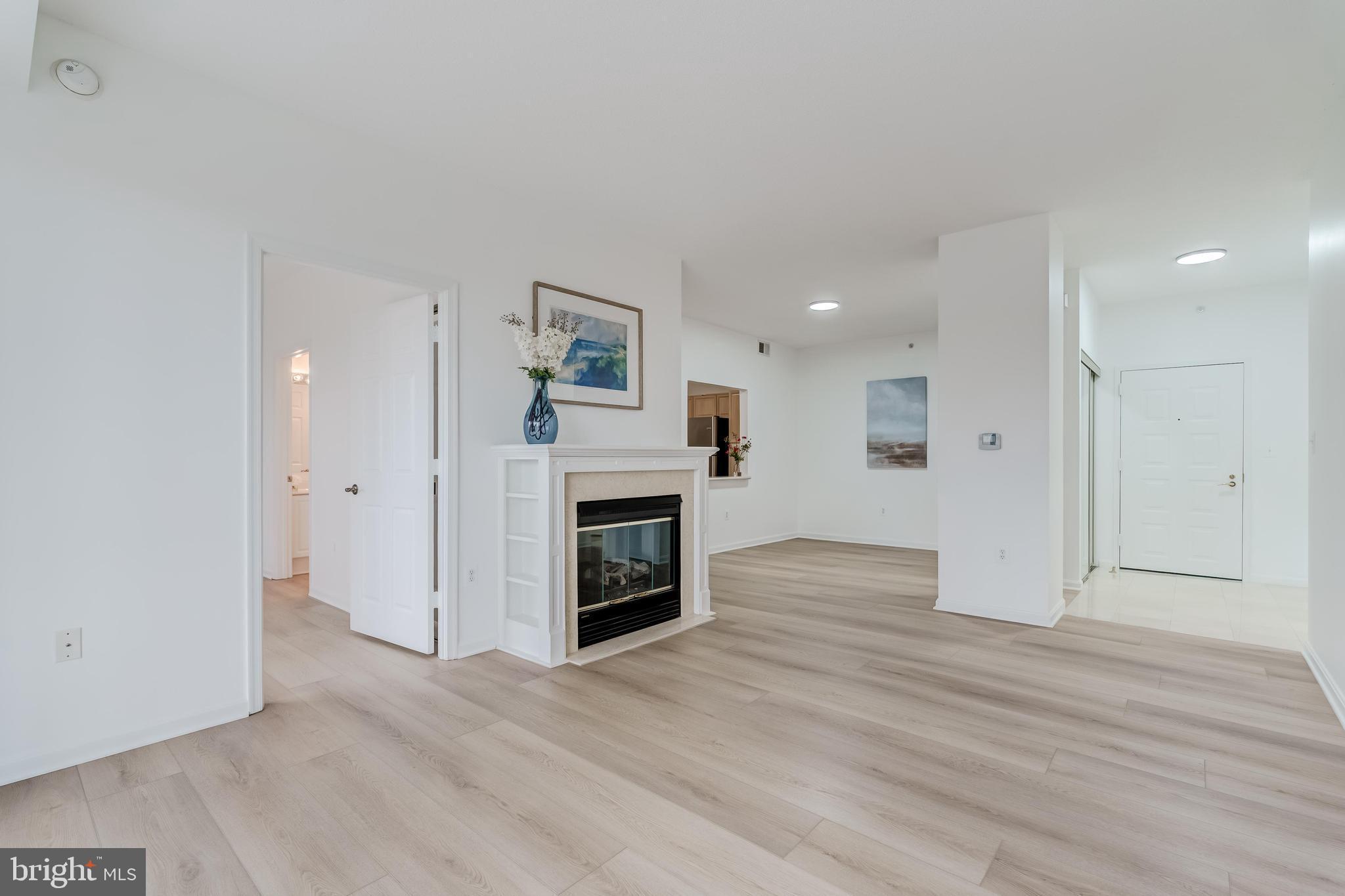 19355 Cypress Ridge Terrace, Unit 114 Leesburg, VA 20176 - Photo 9 of 42 a view of a livingroom with a fireplace a ceiling fan and window