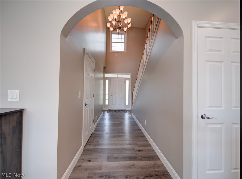 9900 Mentor Road Chardon, OH 44024 - Photo 4 of 49 Hall featuring an inviting chandelier and dark hardwood / wood-style floors