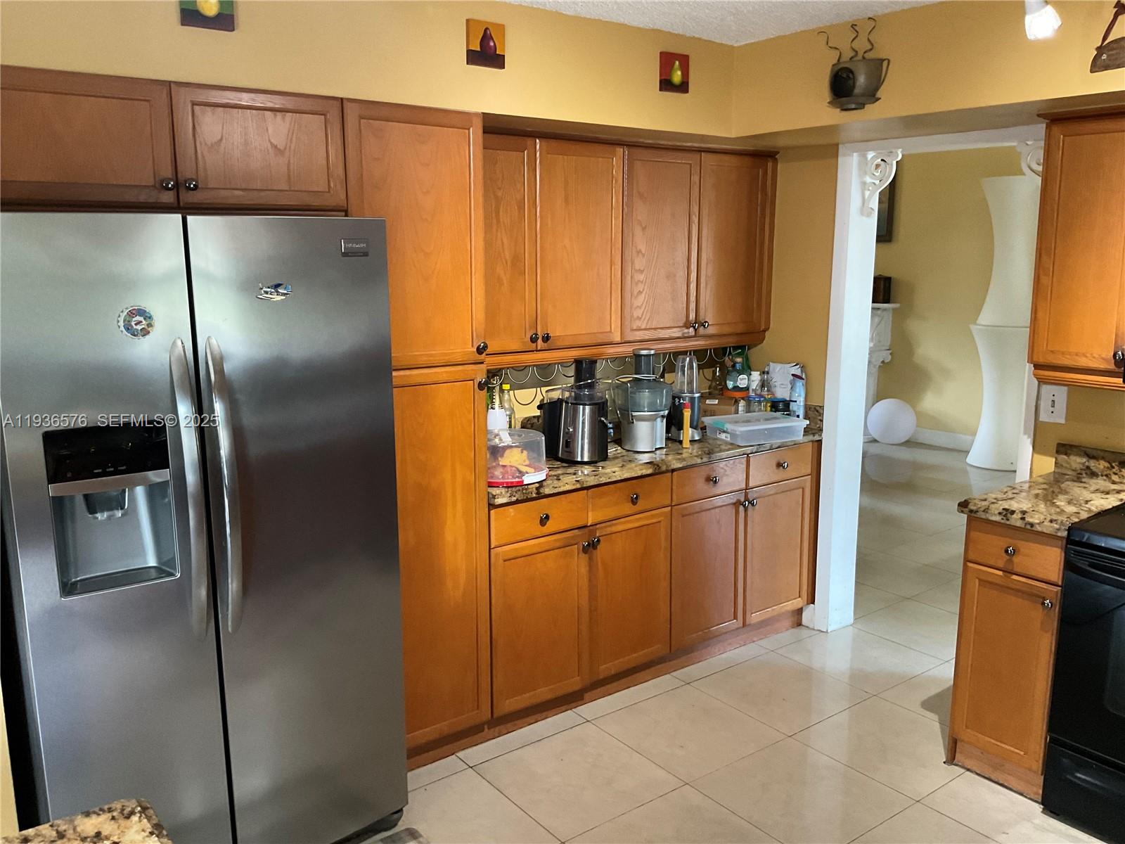 3161 Venice Way Miramar, FL 33025 - Photo 13 of 37 a kitchen with stainless steel appliances granite countertop a refrigerator a stove and a sink