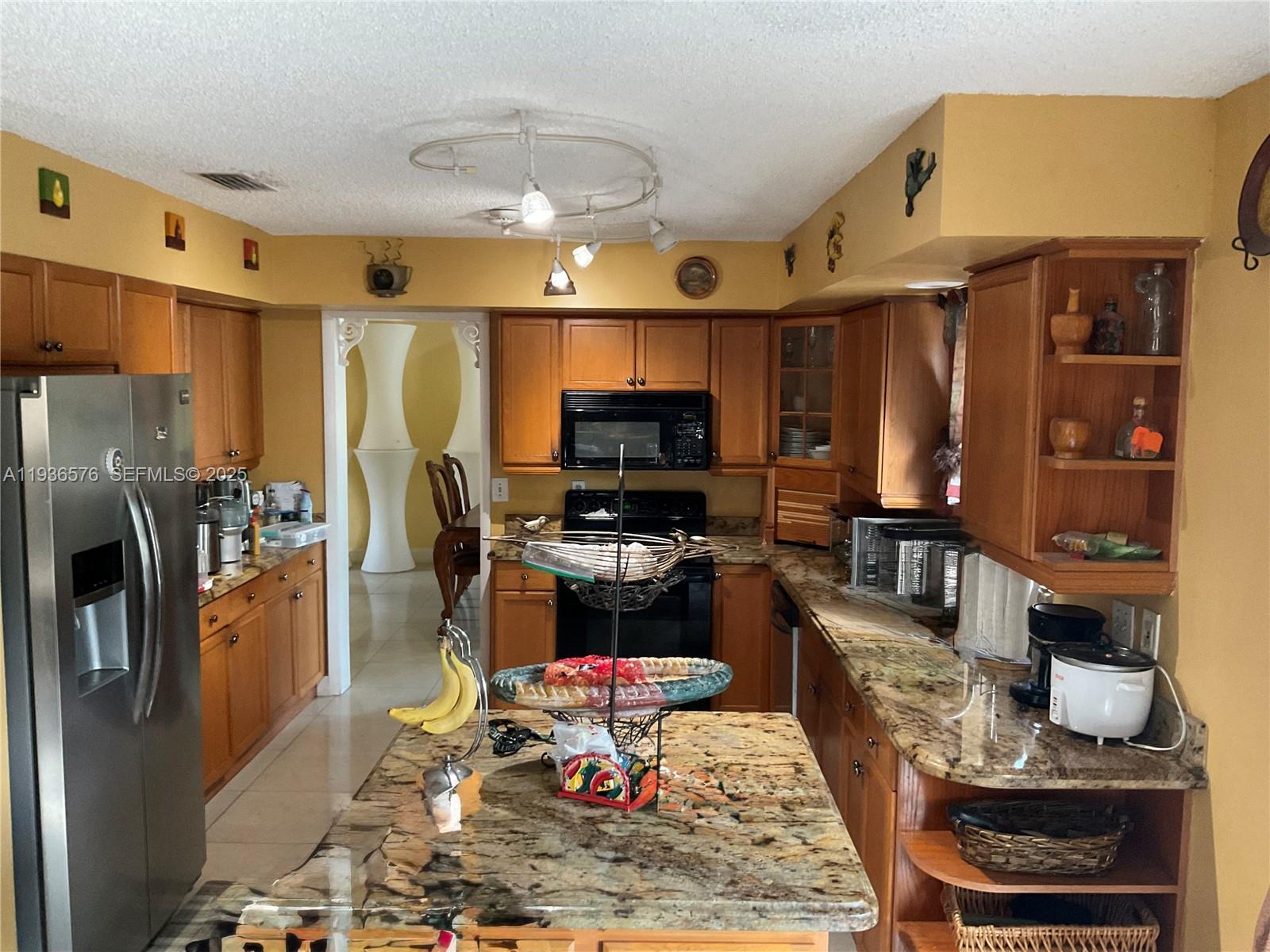 3161 Venice Way Miramar, FL 33025 - Photo 14 of 37 a living room with stainless steel appliances furniture a rug and a view of kitchen