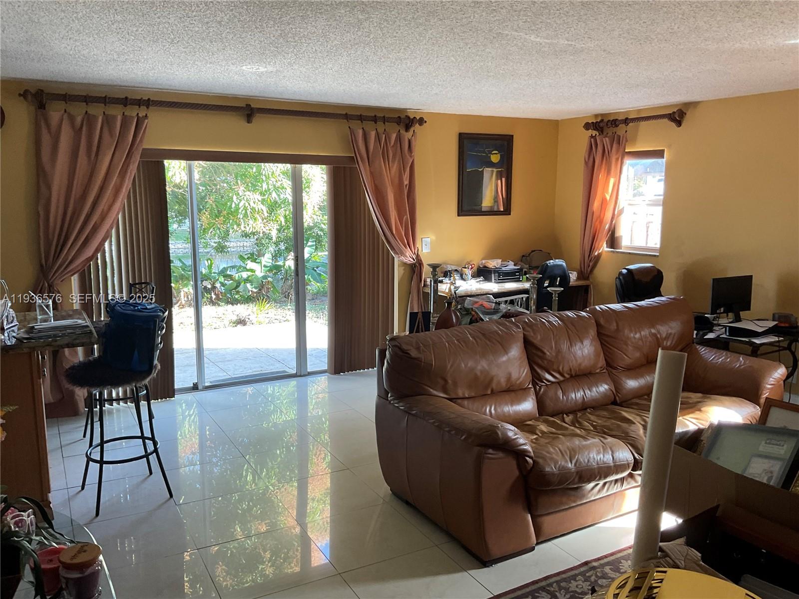 3161 Venice Way Miramar, FL 33025 - Photo 15 of 37 a living room with furniture and a large window