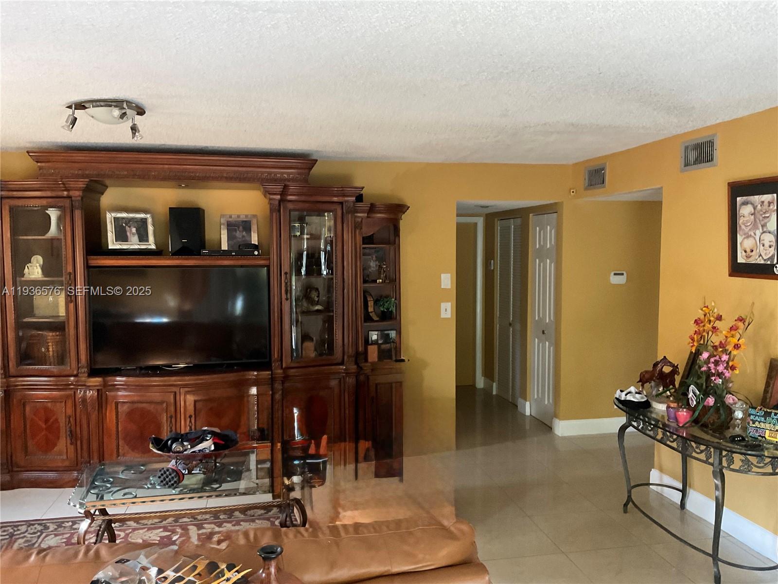 3161 Venice Way Miramar, FL 33025 - Photo 16 of 37 a living room with furniture and a flat screen tv