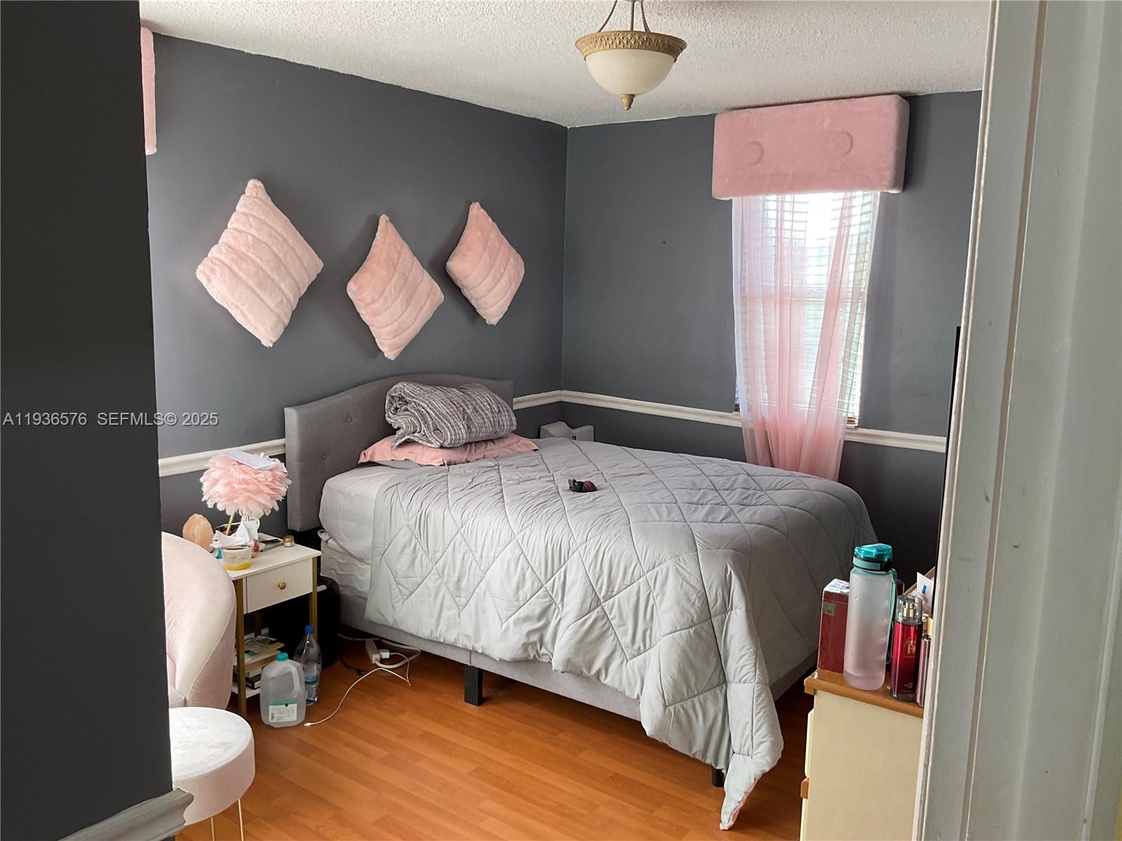 3161 Venice Way Miramar, FL 33025 - Photo 20 of 37 a bedroom with a bed and a mirror