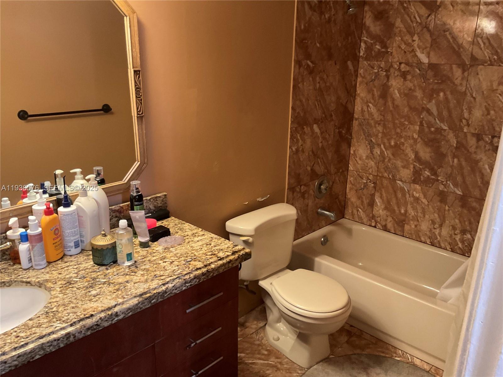 3161 Venice Way Miramar, FL 33025 - Photo 21 of 37 a bathroom with a granite countertop sink mirror vanity and toilet