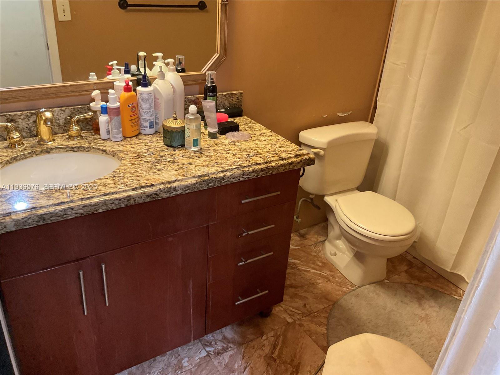 3161 Venice Way Miramar, FL 33025 - Photo 22 of 37 a bathroom with a granite countertop toilet and a sink
