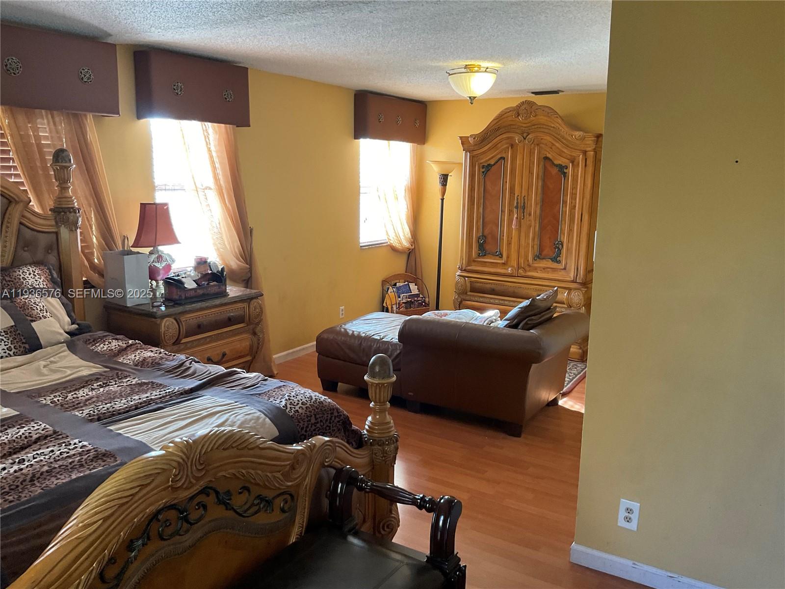 3161 Venice Way Miramar, FL 33025 - Photo 24 of 37 a bedroom with a bed and wooden floor