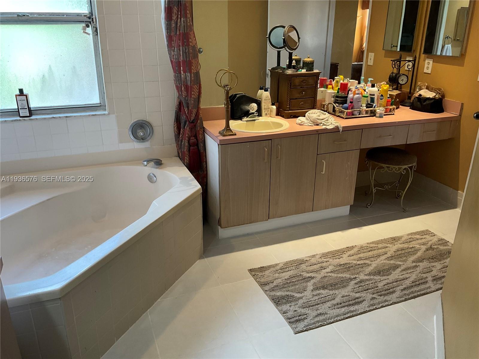 3161 Venice Way Miramar, FL 33025 - Photo 26 of 37 a bathroom with a tub sink and mirror