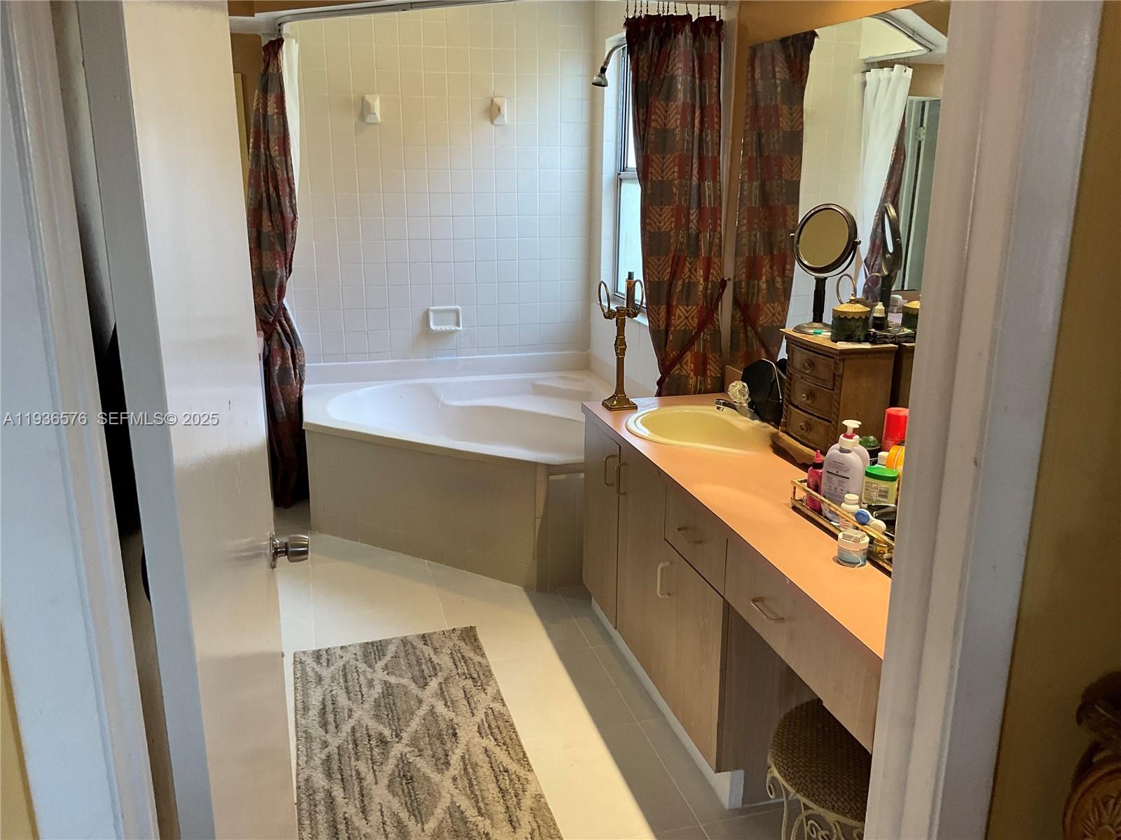 3161 Venice Way Miramar, FL 33025 - Photo 29 of 37 a bathroom with a sink and a mirror