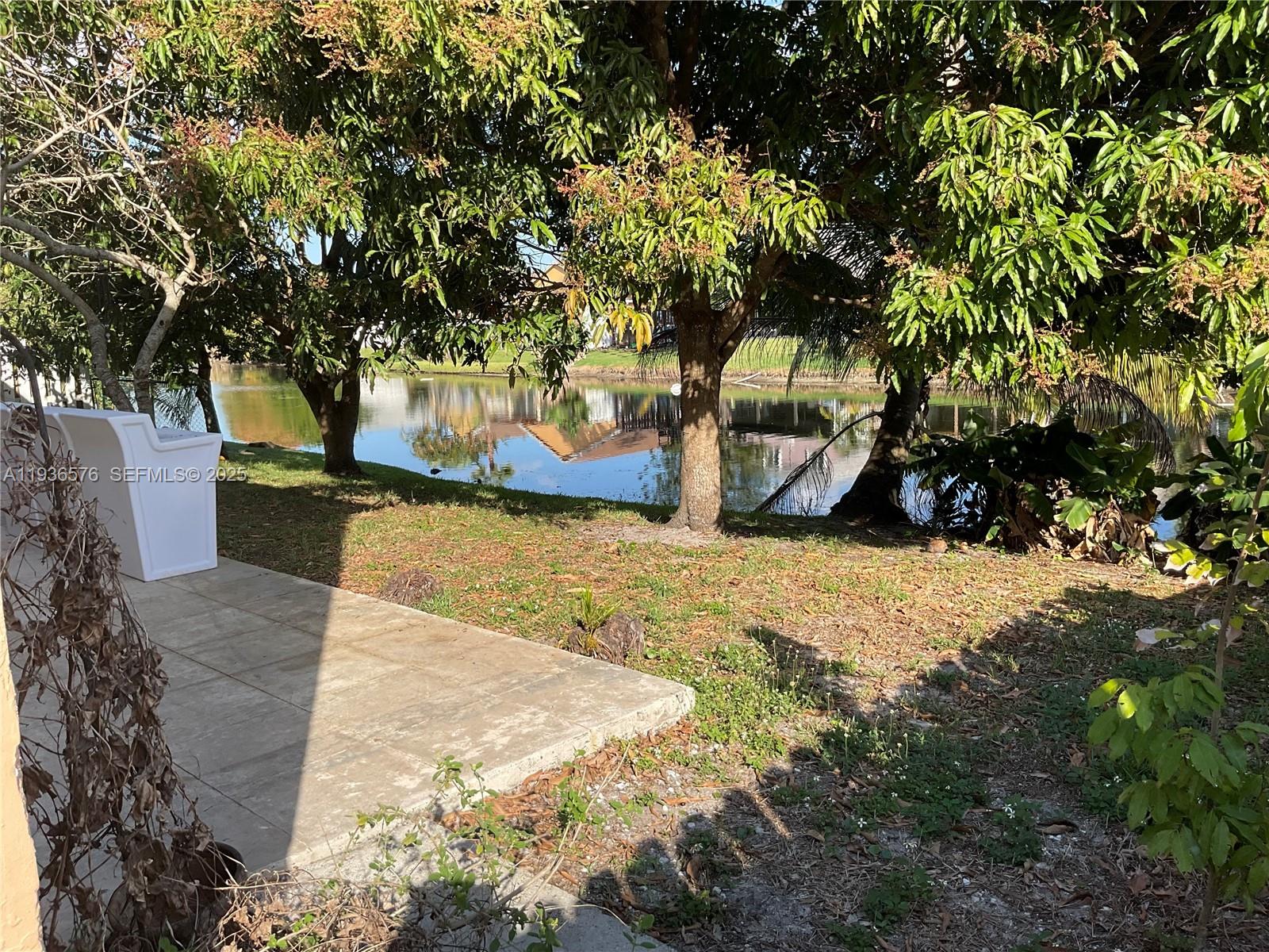 3161 Venice Way Miramar, FL 33025 - Photo 35 of 37 a view of a yard with plants and trees