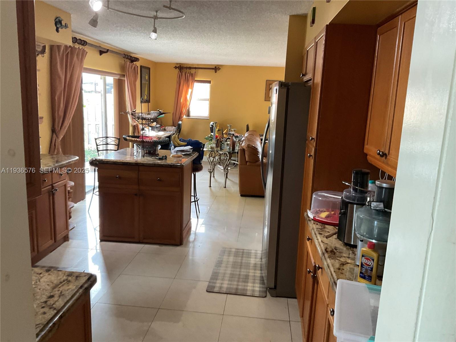 3161 Venice Way Miramar, FL 33025 - Photo 10 of 37 a kitchen with stainless steel appliances granite countertop a refrigerator and a stove
