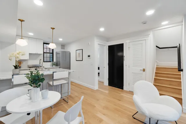 a kitchen with stainless steel appliances kitchen island granite countertop a table and chairs