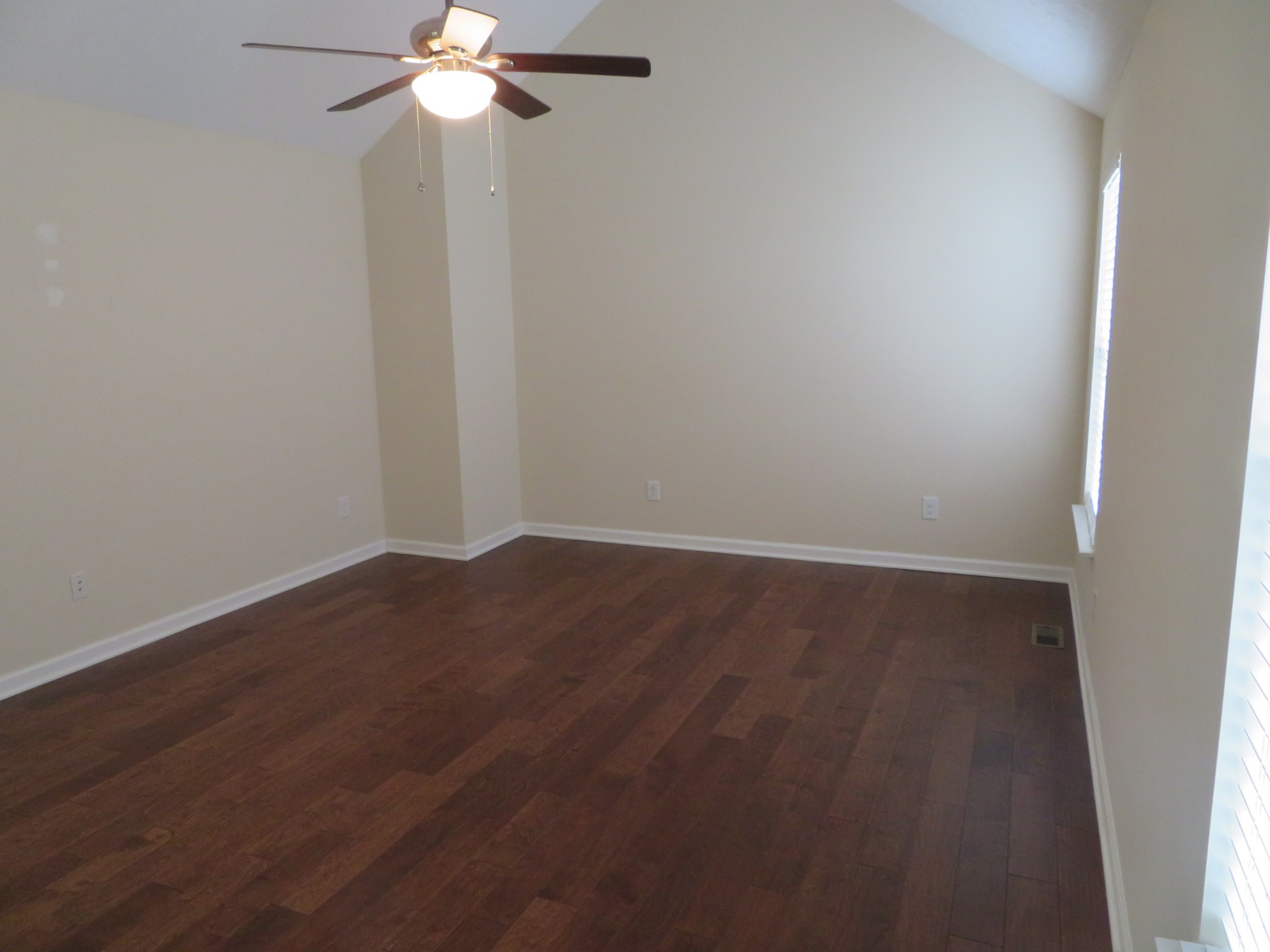 210 Shaub Road Portland, TN 37148 - Photo 16 of 22 an empty room with wooden floor fan and windows