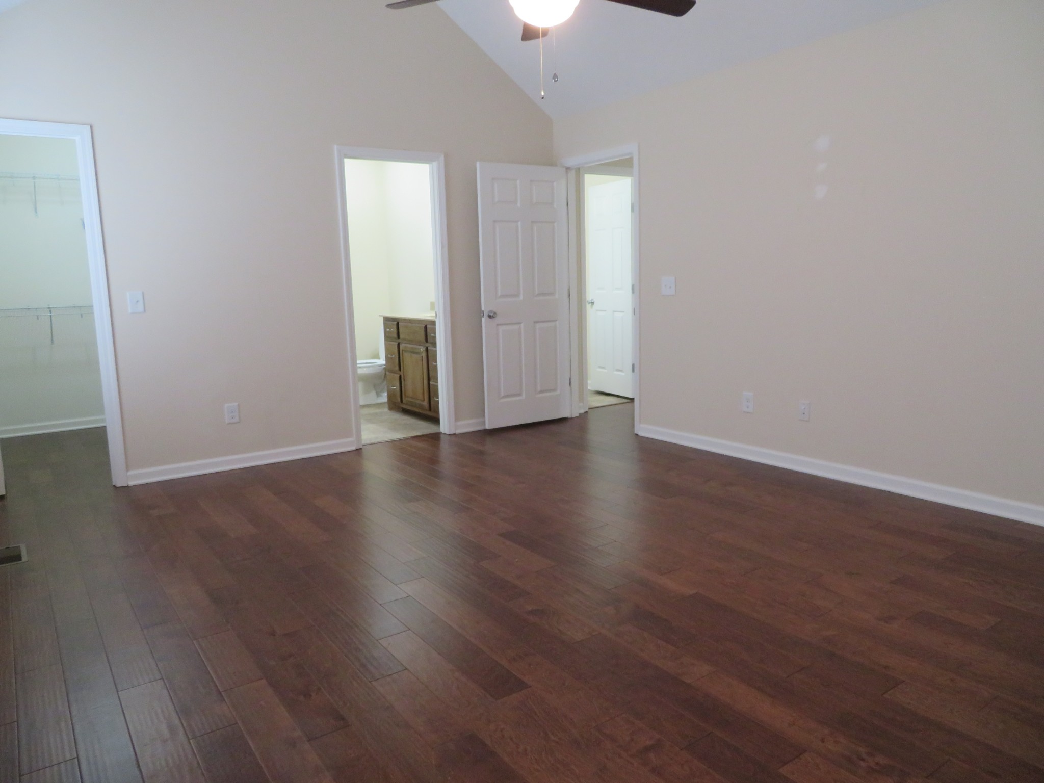 210 Shaub Road Portland, TN 37148 - Photo 17 of 22 an empty room with wooden floor chandelier fan and windows