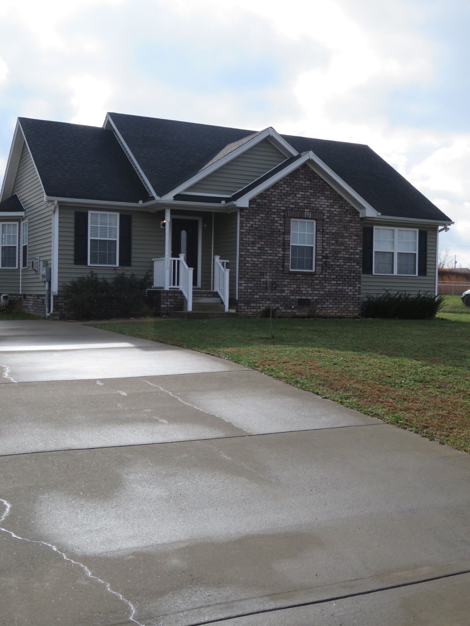 210 Shaub Road Portland, TN 37148 - Photo 3 of 22 a front view of a house with a garden and yard