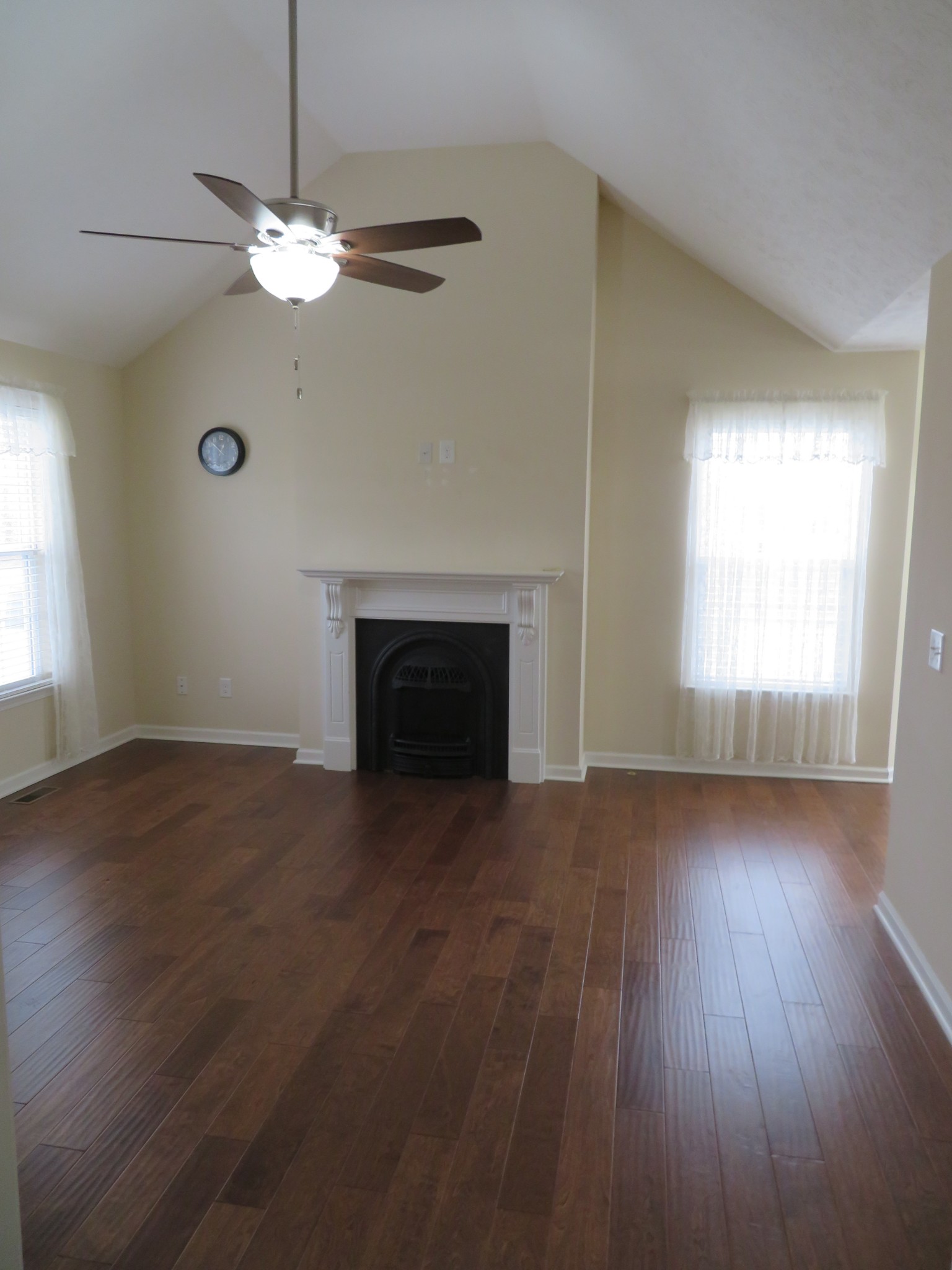 210 Shaub Road Portland, TN 37148 - Photo 4 of 22 an empty room with wooden floor fan and windows