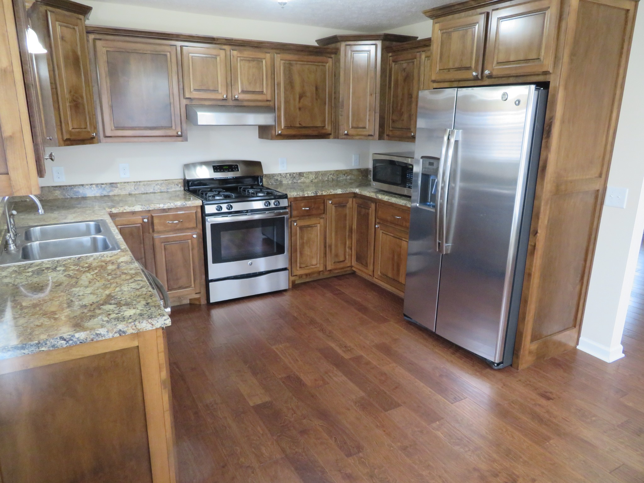 210 Shaub Road Portland, TN 37148 - Photo 9 of 22 a kitchen with granite countertop a refrigerator and a sink