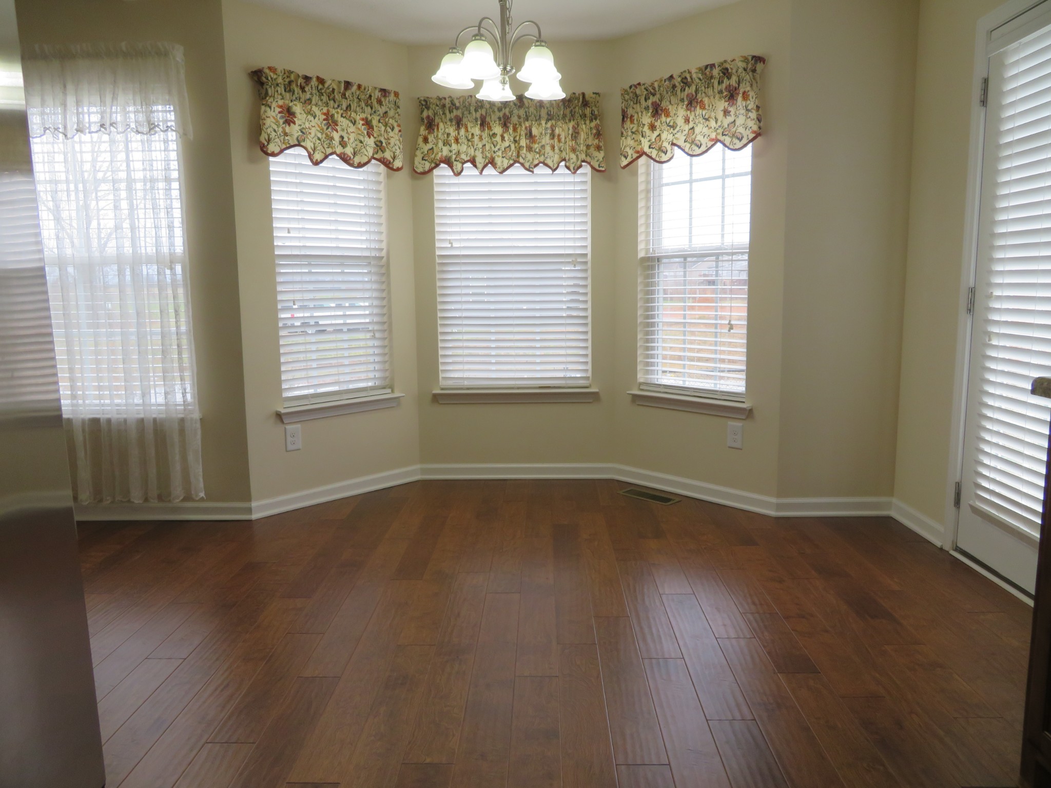 210 Shaub Road Portland, TN 37148 - Photo 10 of 22 a view of an empty room with wooden floor and a window