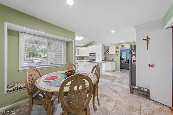a dining room with furniture and window