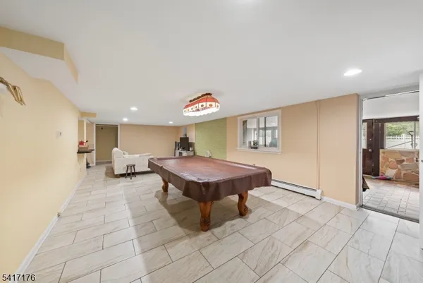 a living room with furniture a flat screen tv and a table