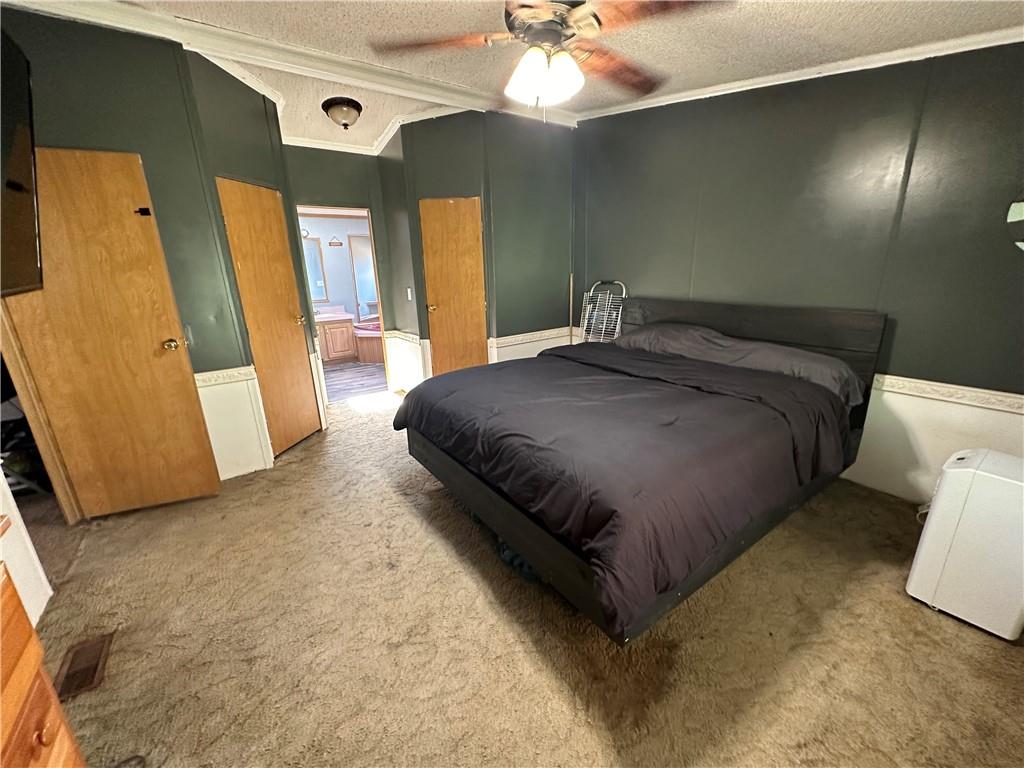 107 Rose Lane Rimersburg, PA 16248 - Photo 16 of 25 a spacious bedroom with a bed and a mirror