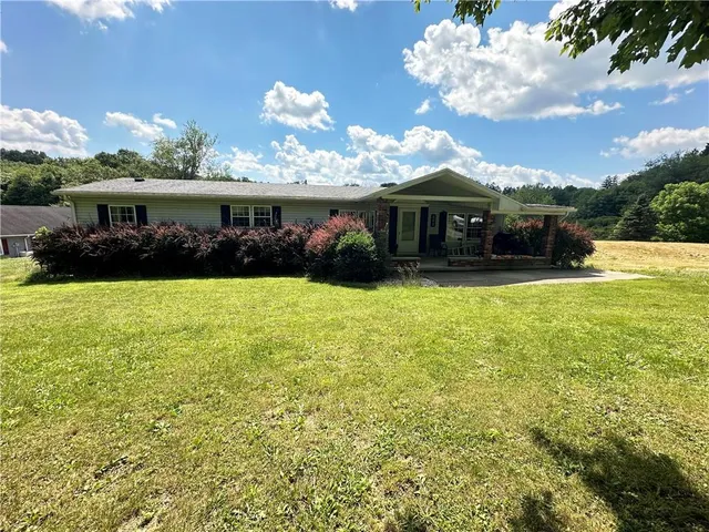 a view of a tree in front of a house