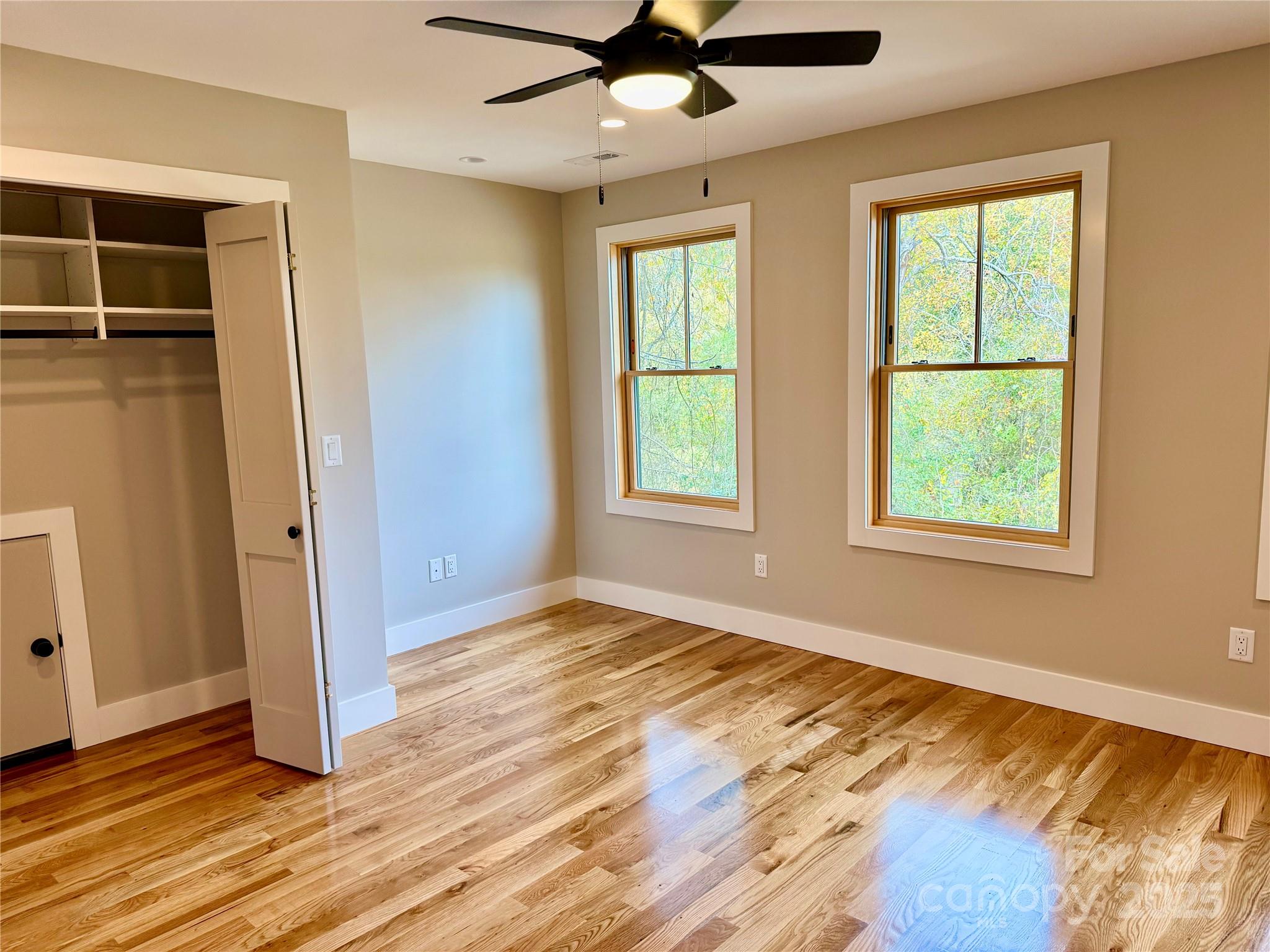 296 Gallimore Road Brevard, NC 28712 - Photo 28 of 36 a view of an empty room with wooden floor and a window