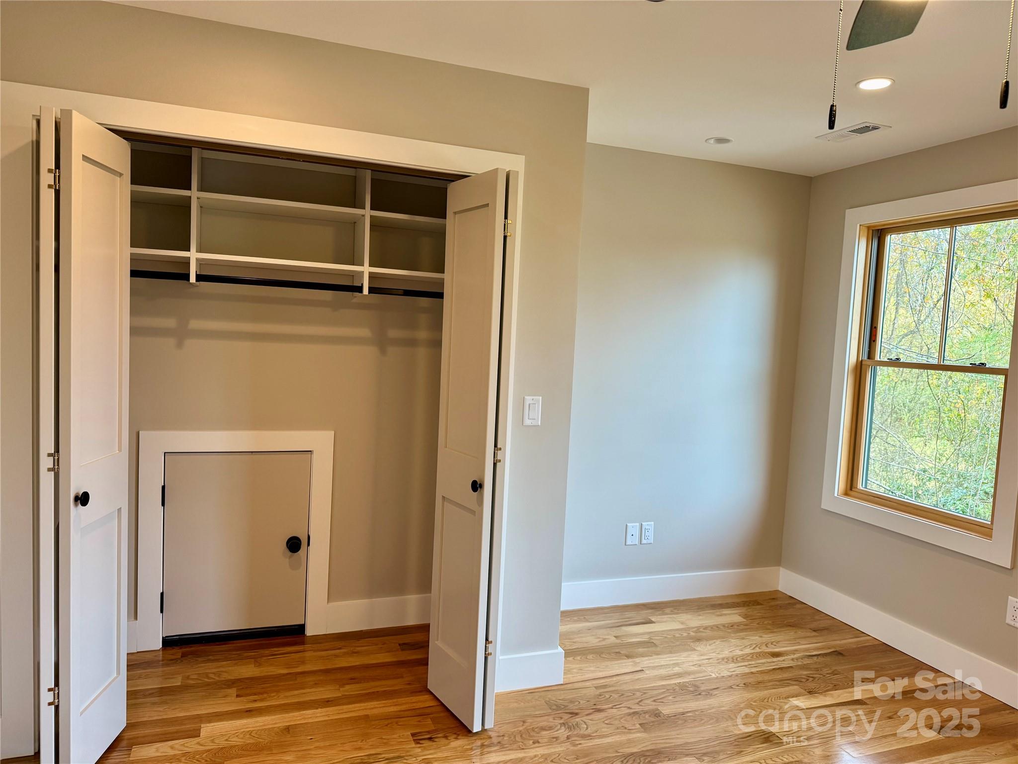 296 Gallimore Road Brevard, NC 28712 - Photo 29 of 36 a view of an empty room with wooden floor and a window