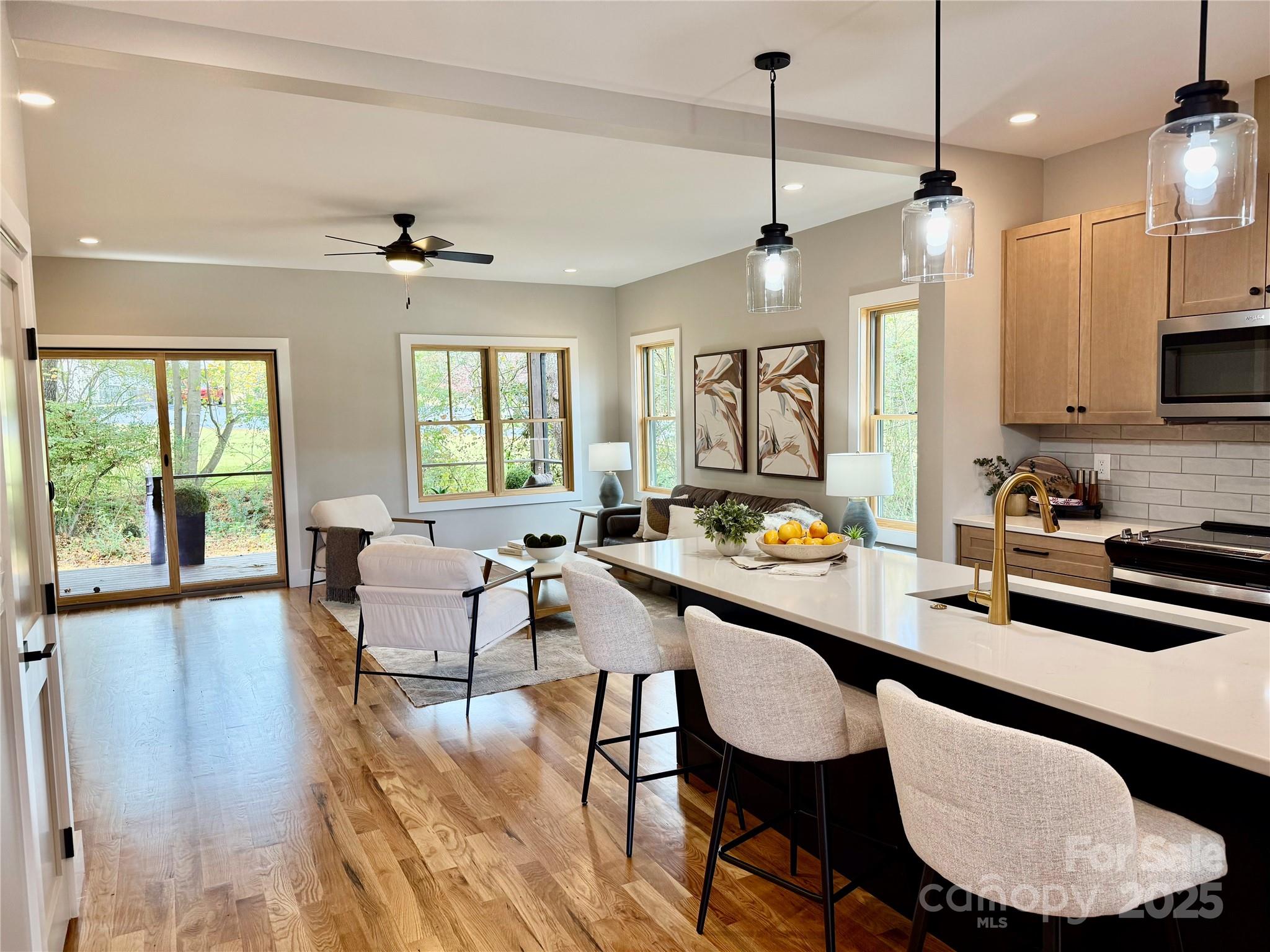 296 Gallimore Road Brevard, NC 28712 - Photo 5 of 36 a room with granite countertop lots of furniture and a chandelier