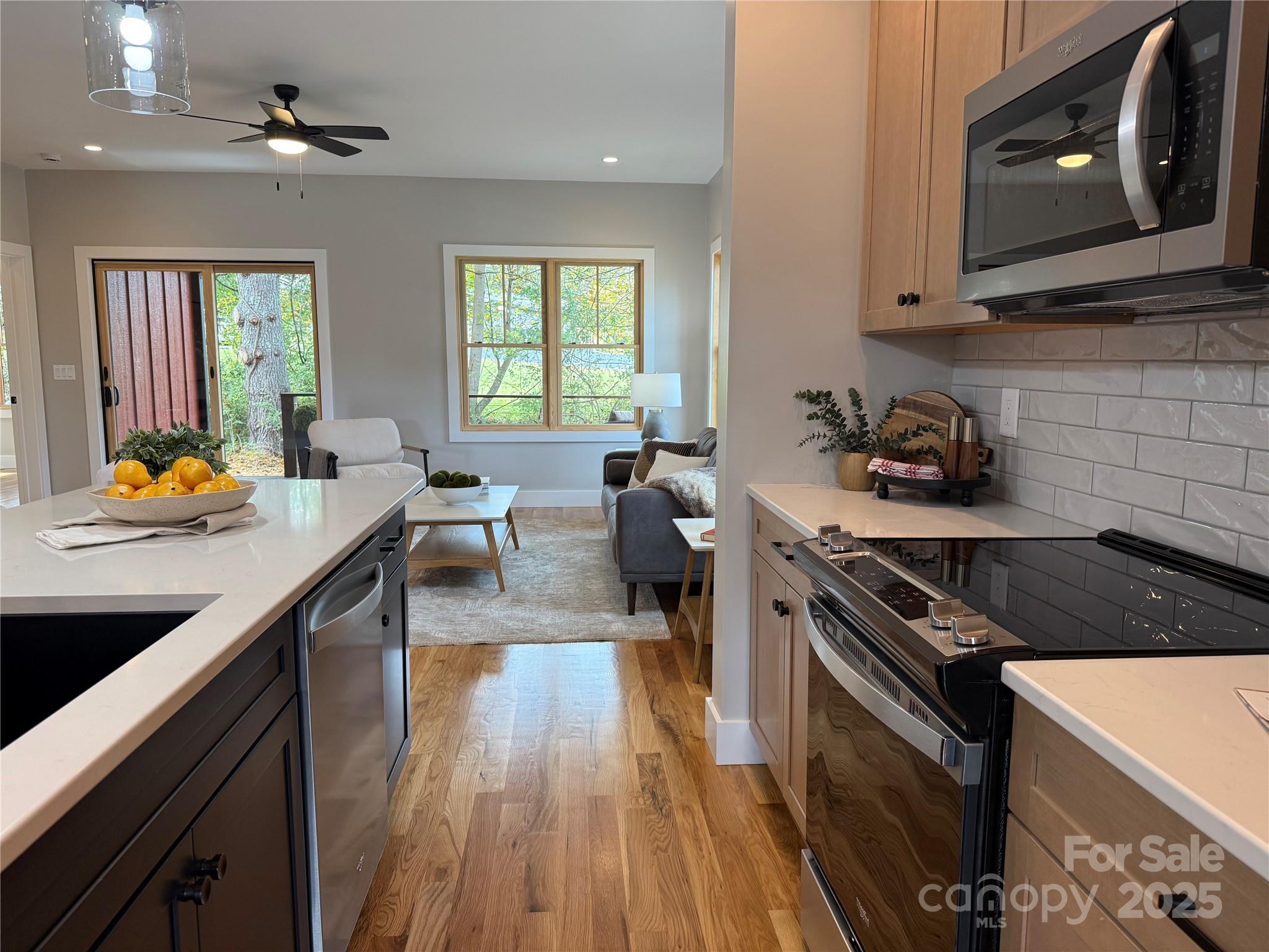 296 Gallimore Road Brevard, NC 28712 - Photo 6 of 36 a kitchen with stainless steel appliances granite countertop a sink stove and cabinets