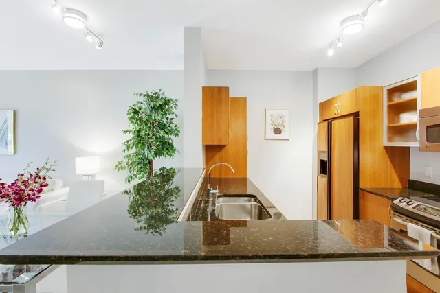 a kitchen with sink and refrigerator