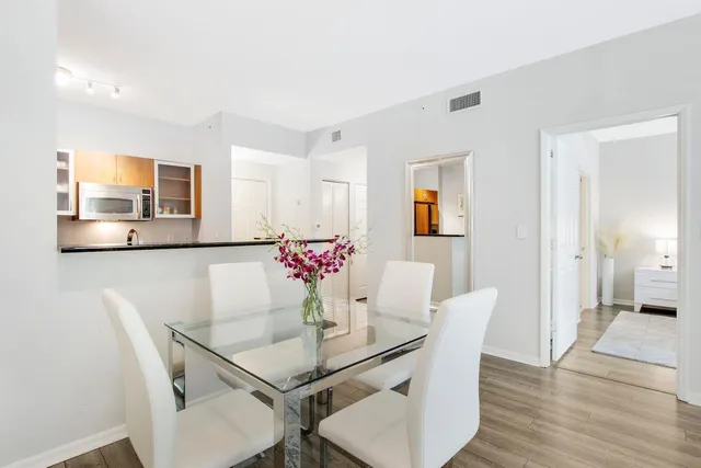 a view of a dining room with furniture and wooden floor