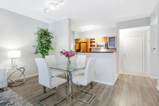 a dining room with furniture and wooden floor