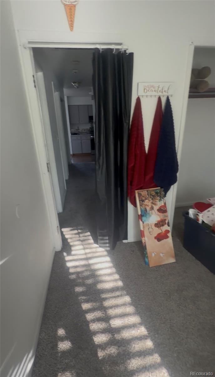 7907 York Street, Unit 3 Denver, CO 80229 - Photo 12 of 13 a bedroom with a bed and a walk in closet