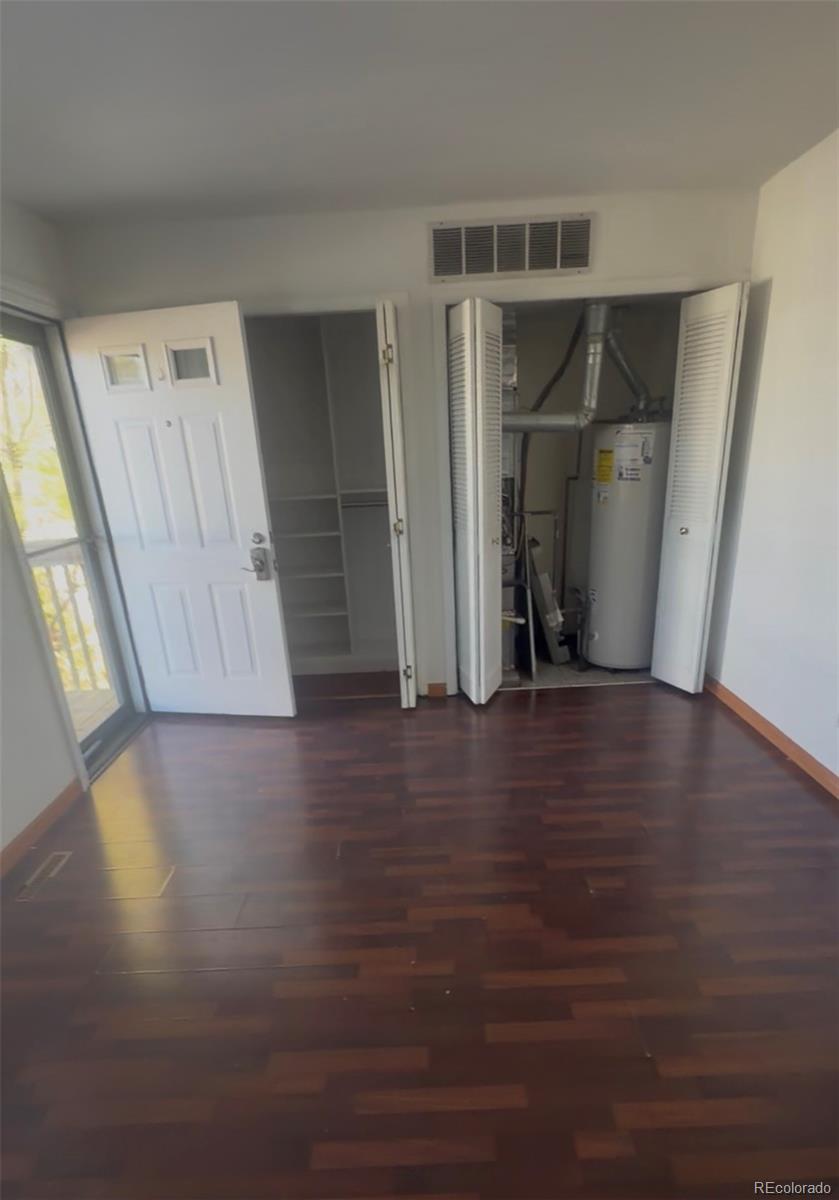 7907 York Street, Unit 3 Denver, CO 80229 - Photo 5 of 13 a view of an empty room with wooden floor and a window