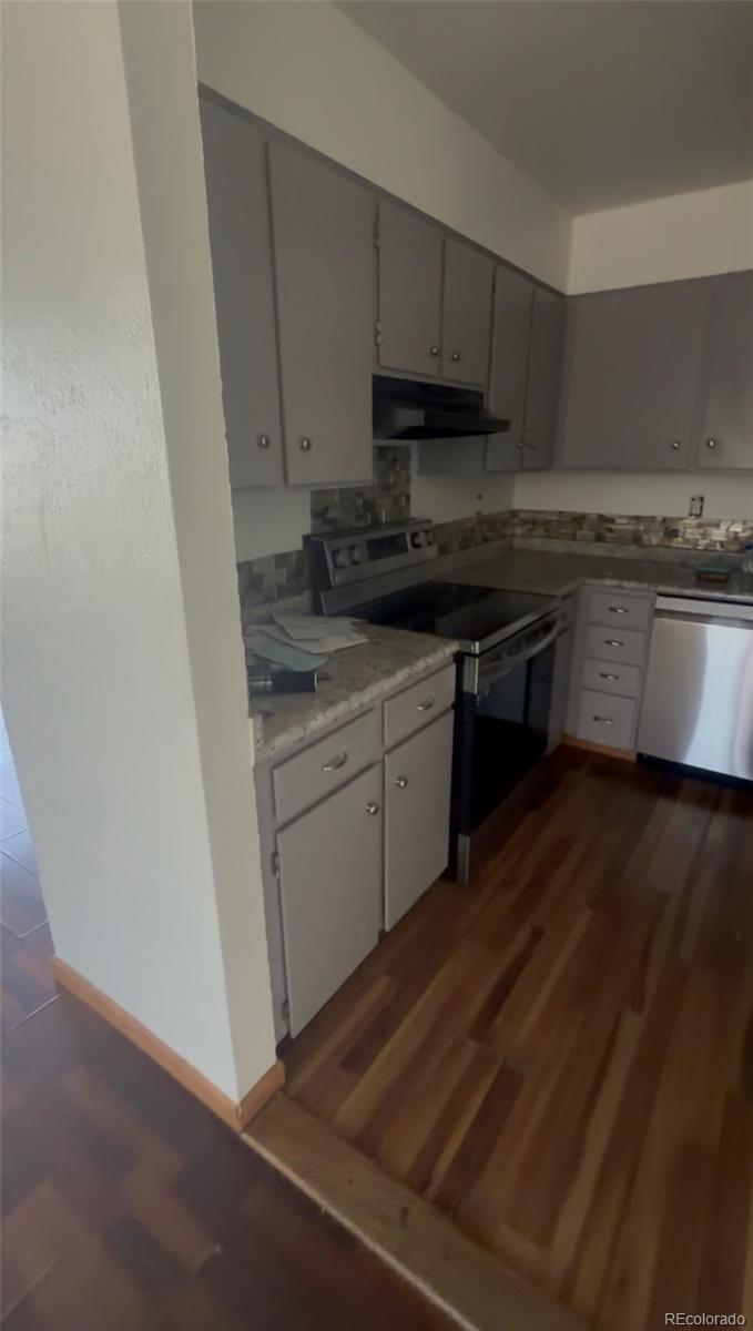 7907 York Street, Unit 3 Denver, CO 80229 - Photo 8 of 13 a kitchen with stainless steel appliances granite countertop a stove a sink and a microwave