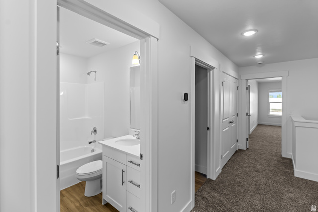 2995 South 265th Street West, Unit 752 Logan, UT 84321 - Photo 8 of 21 Bathroom featuring a white vanity with integrated sink, chrome faucet, and wood-finish flooring