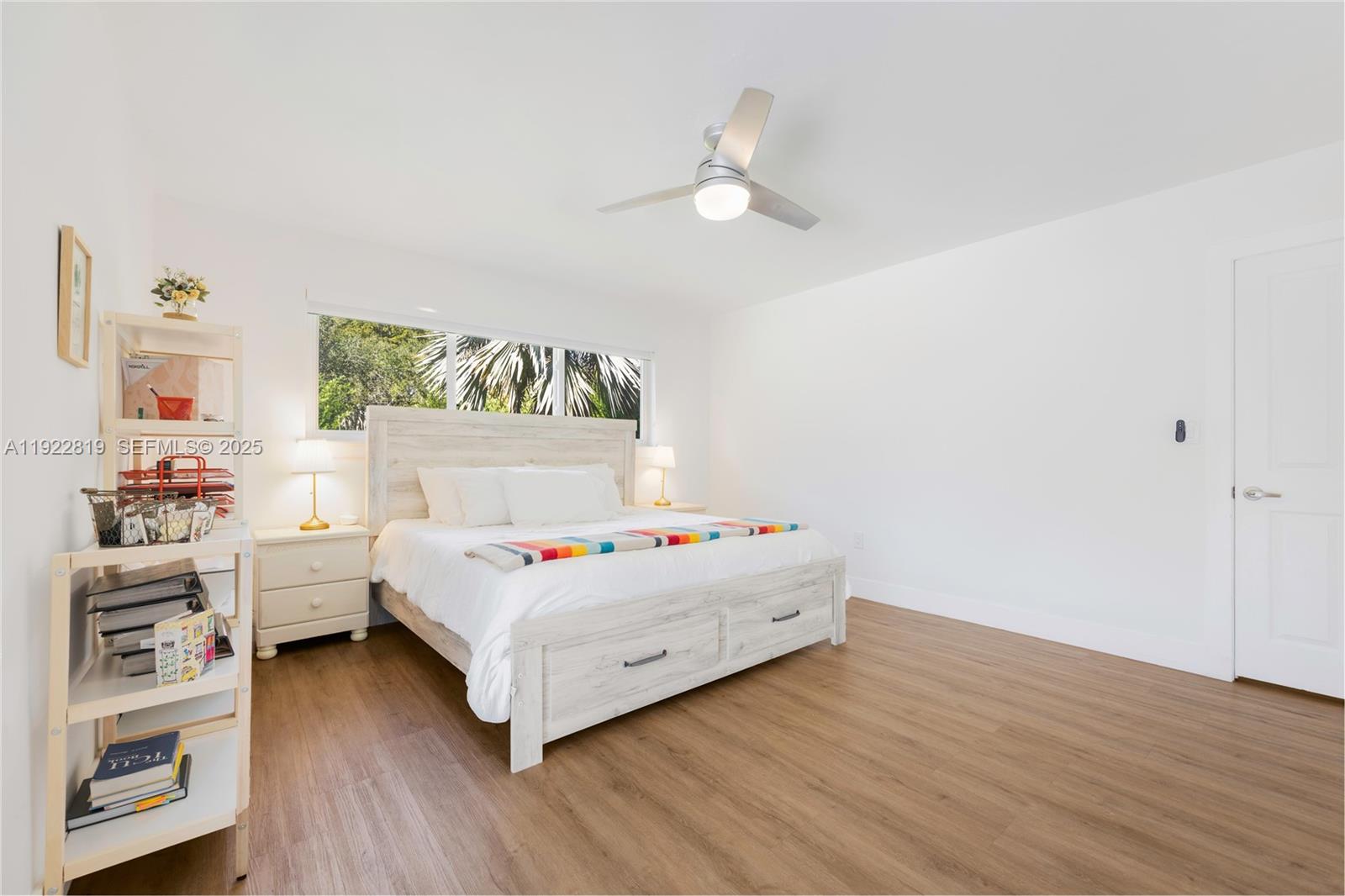 7880 Southwest 132nd Street Pinecrest, FL 33156 - Photo 12 of 22 a white bed sitting in a bedroom next to a window