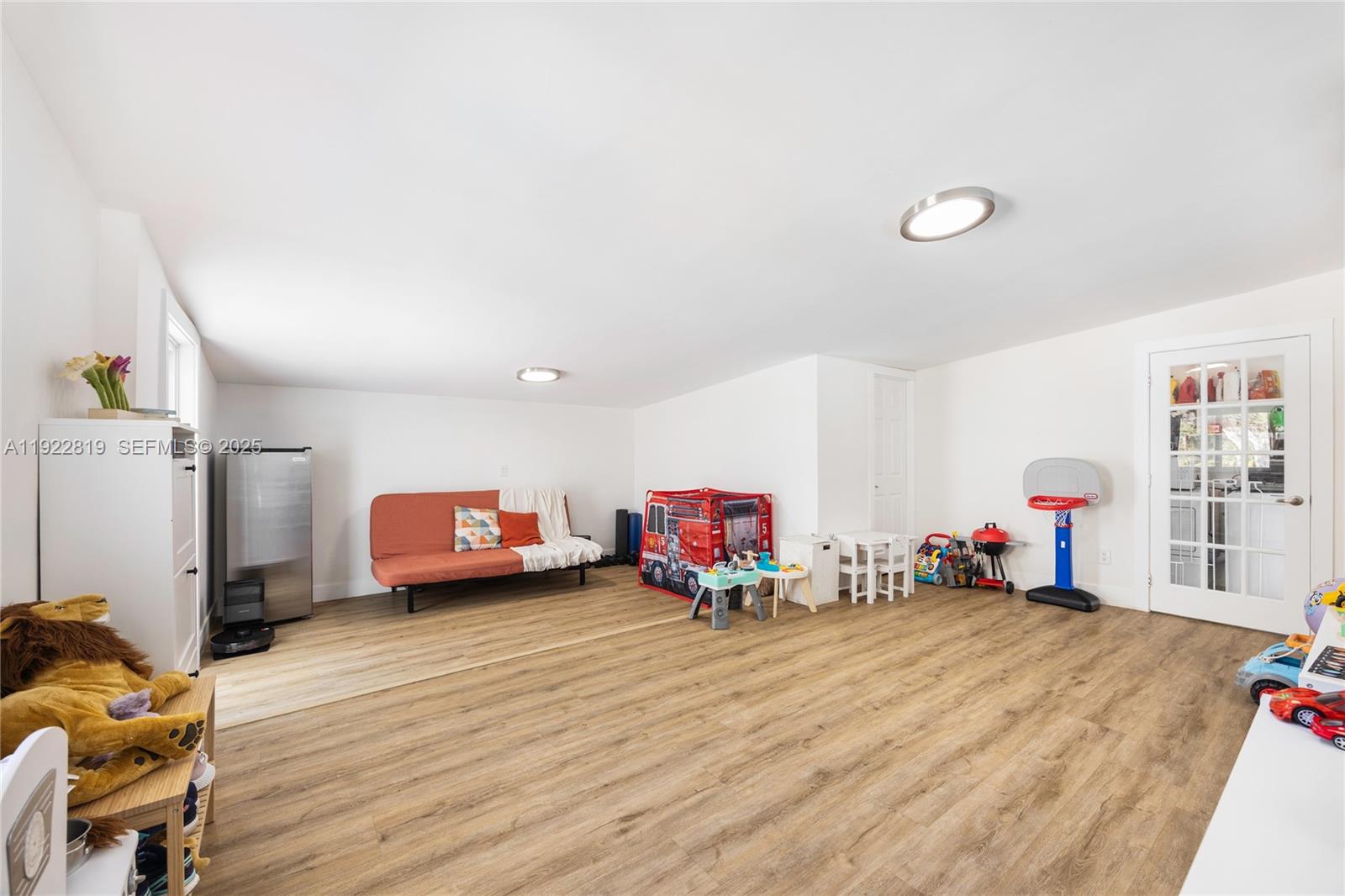 7880 Southwest 132nd Street Pinecrest, FL 33156 - Photo 17 of 22 a living room with lots of furniture and a wooden floor