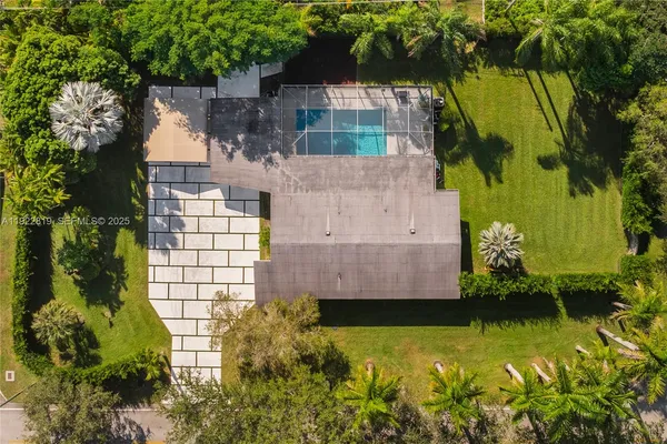 an aerial view of a house with a yard