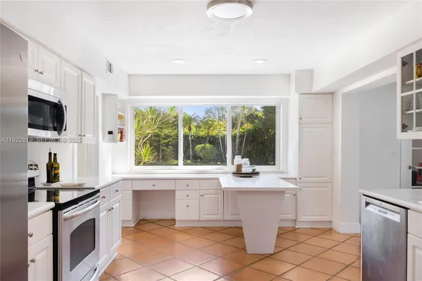 a kitchen with a stove a sink and a refrigerator