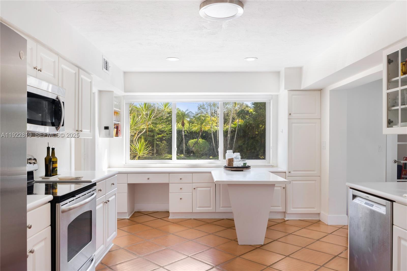 7880 Southwest 132nd Street Pinecrest, FL 33156 - Photo 6 of 22 a kitchen with a stove a sink and a refrigerator