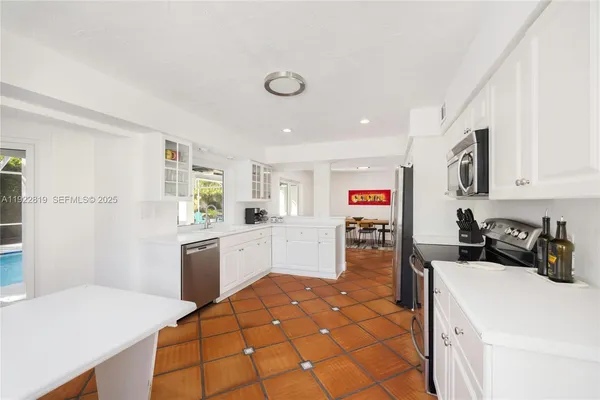 a kitchen with a sink and wooden floor