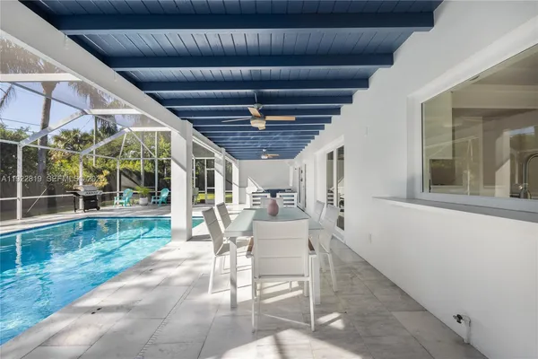 a view of a porch with chairs and couches