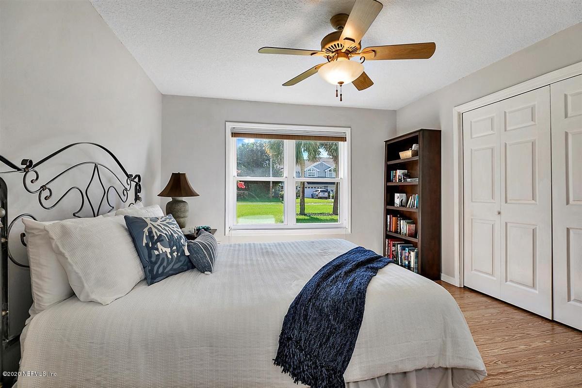 1870 Seminole Road Atlantic Beach, FL 32233 - Photo 15 of 27 a spacious bedroom with a bed a couch and a window